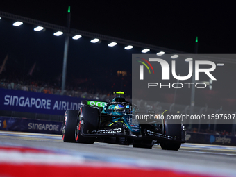 Fernando Alonso of Spain and Aston Martin Aramco F1 Team drives to the grid ahead of the F1 Grand Prix of Singapore at Marina Bay Street Cir...