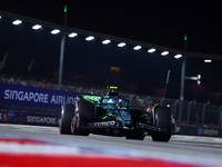 Fernando Alonso of Spain and Aston Martin Aramco F1 Team drives to the grid ahead of the F1 Grand Prix of Singapore at Marina Bay Street Cir...