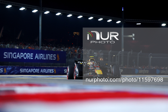 Sergio Perez of Mexico and Red Bull Racing-Honda RBPT drives to the grid ahead of the F1 Grand Prix of Singapore at Marina Bay Street Circui...