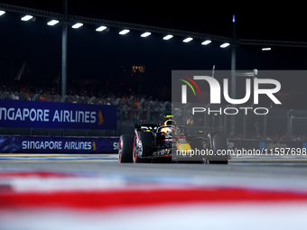 Sergio Perez of Mexico and Red Bull Racing-Honda RBPT drives to the grid ahead of the F1 Grand Prix of Singapore at Marina Bay Street Circui...