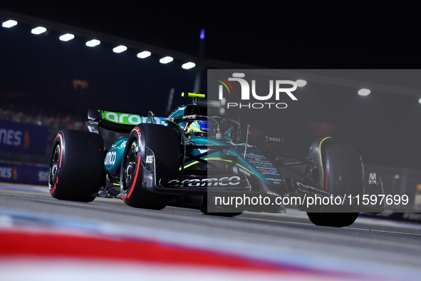 Fernando Alonso of Spain and Aston Martin Aramco F1 Team drives to the grid ahead of the F1 Grand Prix of Singapore at Marina Bay Street Cir...