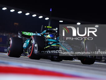 Fernando Alonso of Spain and Aston Martin Aramco F1 Team drives to the grid ahead of the F1 Grand Prix of Singapore at Marina Bay Street Cir...