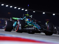 Fernando Alonso of Spain and Aston Martin Aramco F1 Team drives to the grid ahead of the F1 Grand Prix of Singapore at Marina Bay Street Cir...