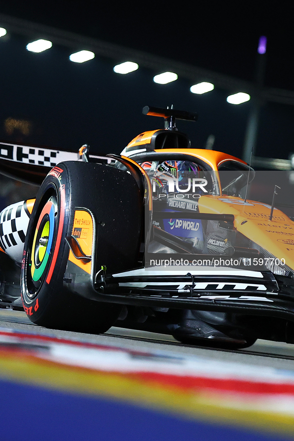 Oscar Piastri of Australia and the McLaren Formula 1 Team drives to the grid ahead of the F1 Grand Prix of Singapore at Marina Bay Street Ci...