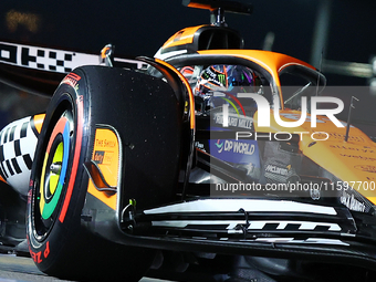 Oscar Piastri of Australia and the McLaren Formula 1 Team drives to the grid ahead of the F1 Grand Prix of Singapore at Marina Bay Street Ci...