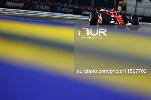 Charles Leclerc of Monaco and Scuderia Ferrari drives to the grid ahead of the F1 Grand Prix of Singapore at Marina Bay Street Circuit in Si...