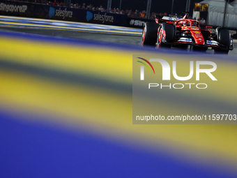 Charles Leclerc of Monaco and Scuderia Ferrari drives to the grid ahead of the F1 Grand Prix of Singapore at Marina Bay Street Circuit in Si...