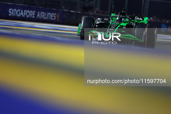 Valtteri Bottas of Finland and Stake F1 Team Kick Sauber drives to the grid ahead of the F1 Grand Prix of Singapore at Marina Bay Street Cir...