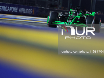 Valtteri Bottas of Finland and Stake F1 Team Kick Sauber drives to the grid ahead of the F1 Grand Prix of Singapore at Marina Bay Street Cir...