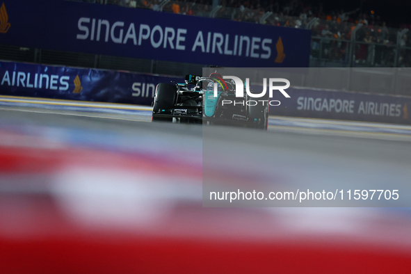 George Russell of the United Kingdom and Mercedes-AMG Petronas F1 Team drives to the grid ahead of the F1 Grand Prix of Singapore at Marina...