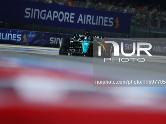 George Russell of the United Kingdom and Mercedes-AMG Petronas F1 Team drives to the grid ahead of the F1 Grand Prix of Singapore at Marina...