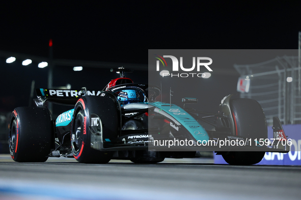 George Russell of the United Kingdom and Mercedes-AMG Petronas F1 Team drives to the grid ahead of the F1 Grand Prix of Singapore at Marina...