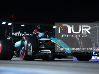 George Russell of the United Kingdom and Mercedes-AMG Petronas F1 Team drives to the grid ahead of the F1 Grand Prix of Singapore at Marina...