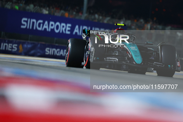 Lewis Hamilton of the United Kingdom and Mercedes-AMG Petronas F1 Team drives to the grid ahead of the F1 Grand Prix of Singapore at Marina...