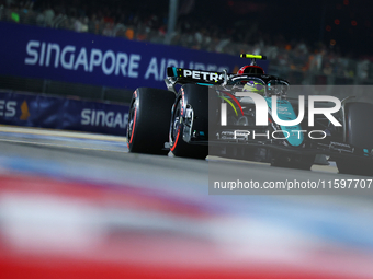 Lewis Hamilton of the United Kingdom and Mercedes-AMG Petronas F1 Team drives to the grid ahead of the F1 Grand Prix of Singapore at Marina...