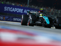 Lewis Hamilton of the United Kingdom and Mercedes-AMG Petronas F1 Team drives to the grid ahead of the F1 Grand Prix of Singapore at Marina...