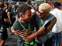 Fencer Miles Chamley-Watson (right) reacts on the grid ahead of the F1 Grand Prix of Singapore at Marina Bay Street Circuit in Singapore, Si...