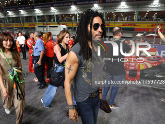 Lenny Kravitz walks on the grid ahead of the F1 Grand Prix of Singapore at Marina Bay Street Circuit in Singapore, Singapore, on September 2...