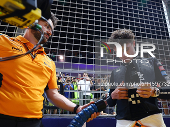 Lando Norris of the United Kingdom and McLaren Formula 1 Team prepares for the race on the grid ahead of the F1 Grand Prix of Singapore at M...