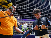 Lando Norris of the United Kingdom and McLaren Formula 1 Team prepares for the race on the grid ahead of the F1 Grand Prix of Singapore at M...