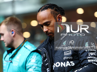 Lewis Hamilton of the United Kingdom and Mercedes-AMG Petronas F1 Team stands on the grid ahead of the F1 Grand Prix of Singapore at Marina...