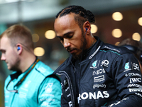 Lewis Hamilton of the United Kingdom and Mercedes-AMG Petronas F1 Team stands on the grid ahead of the F1 Grand Prix of Singapore at Marina...