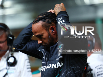 Lewis Hamilton of the United Kingdom and Mercedes-AMG Petronas F1 Team stands on the grid ahead of the F1 Grand Prix of Singapore at Marina...