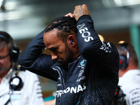 Lewis Hamilton of the United Kingdom and Mercedes-AMG Petronas F1 Team stands on the grid ahead of the F1 Grand Prix of Singapore at Marina...