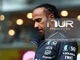 Lewis Hamilton of the United Kingdom and Mercedes-AMG Petronas F1 Team stands on the grid ahead of the F1 Grand Prix of Singapore at Marina...