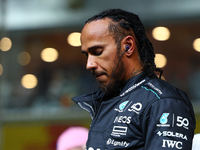 Lewis Hamilton of the United Kingdom and Mercedes-AMG Petronas F1 Team stands on the grid ahead of the F1 Grand Prix of Singapore at Marina...