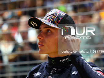 Oscar Piastri of Australia and the McLaren Formula 1 Team stand on the grid ahead of the F1 Grand Prix of Singapore at Marina Bay Street Cir...