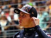 Oscar Piastri of Australia and the McLaren Formula 1 Team stand on the grid ahead of the F1 Grand Prix of Singapore at Marina Bay Street Cir...