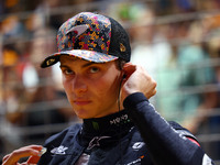 Oscar Piastri of Australia and the McLaren Formula 1 Team stand on the grid ahead of the F1 Grand Prix of Singapore at Marina Bay Street Cir...