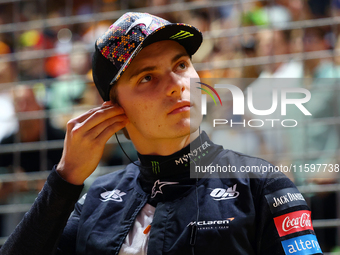 Oscar Piastri of Australia and the McLaren Formula 1 Team stand on the grid ahead of the F1 Grand Prix of Singapore at Marina Bay Street Cir...