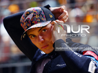 Oscar Piastri of Australia and the McLaren Formula 1 Team stand on the grid ahead of the F1 Grand Prix of Singapore at Marina Bay Street Cir...