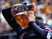 Oscar Piastri of Australia and the McLaren Formula 1 Team stand on the grid ahead of the F1 Grand Prix of Singapore at Marina Bay Street Cir...