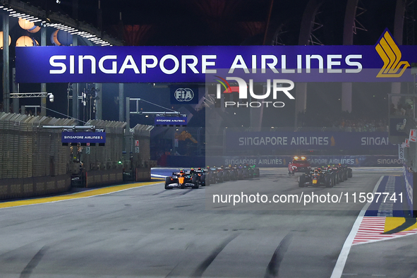 Cars line up on the starting grid during the F1 Grand Prix of Singapore at Marina Bay Street Circuit in Singapore, Singapore, on September 2...