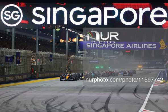 Lando Norris of the United Kingdom drives the McLaren Formula 1 Team MCL38 off the line on the opening lap during the F1 Grand Prix of Singa...