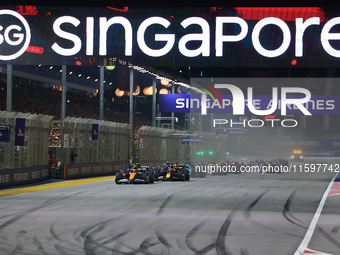 Lando Norris of the United Kingdom drives the McLaren Formula 1 Team MCL38 off the line on the opening lap during the F1 Grand Prix of Singa...