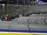 Lando Norris of the United Kingdom and McLaren Formula 1 Team drives on the opening lap during the F1 Grand Prix of Singapore at Marina Bay...