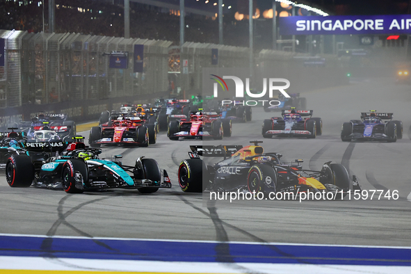 Max Verstappen of the Netherlands and Red Bull Racing-Honda RBPT and Lewis Hamilton of the United Kingdom and Mercedes-AMG Petronas F1 Team...