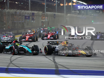 Max Verstappen of the Netherlands and Red Bull Racing-Honda RBPT and Lewis Hamilton of the United Kingdom and Mercedes-AMG Petronas F1 Team...