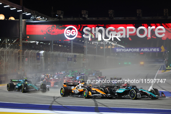 Oscar Piastri of Australia and the McLaren Formula 1 Team and George Russell of the United Kingdom and the Mercedes-AMG Petronas F1 Team dri...