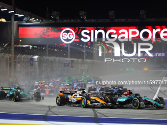 Oscar Piastri of Australia and the McLaren Formula 1 Team and George Russell of the United Kingdom and the Mercedes-AMG Petronas F1 Team dri...