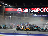 Oscar Piastri of Australia and the McLaren Formula 1 Team and George Russell of the United Kingdom and the Mercedes-AMG Petronas F1 Team dri...