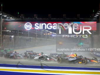 Sergio Perez of Mexico drives the Red Bull Racing-Honda RBPT RB20 on the opening lap during the F1 Grand Prix of Singapore at Marina Bay Str...