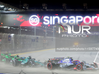 Daniel Ricciardo of Australia drives the Visa Cash App RB F1 Team VCARB 01 on the opening lap during the F1 Grand Prix of Singapore at Marin...