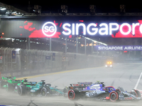 Daniel Ricciardo of Australia drives the Visa Cash App RB F1 Team VCARB 01 on the opening lap during the F1 Grand Prix of Singapore at Marin...