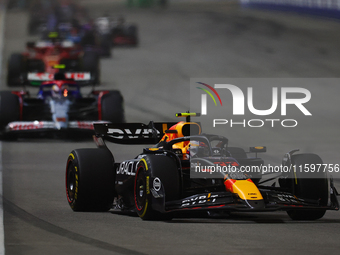 Sergio Perez of Mexico drives the Red Bull Racing-Honda RBPT RB20 during the F1 Grand Prix of Singapore at Marina Bay Street Circuit in Sing...