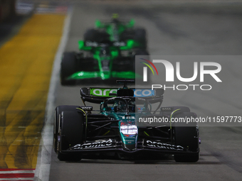 Lance Stroll of Canada drives the Aston Martin Aramco F1 Team AMR25 during the F1 Grand Prix of Singapore at Marina Bay Street Circuit in Si...